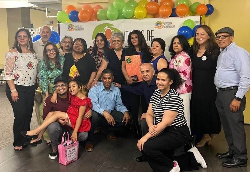 A large group celebrating at a Manos de Misericordia community event