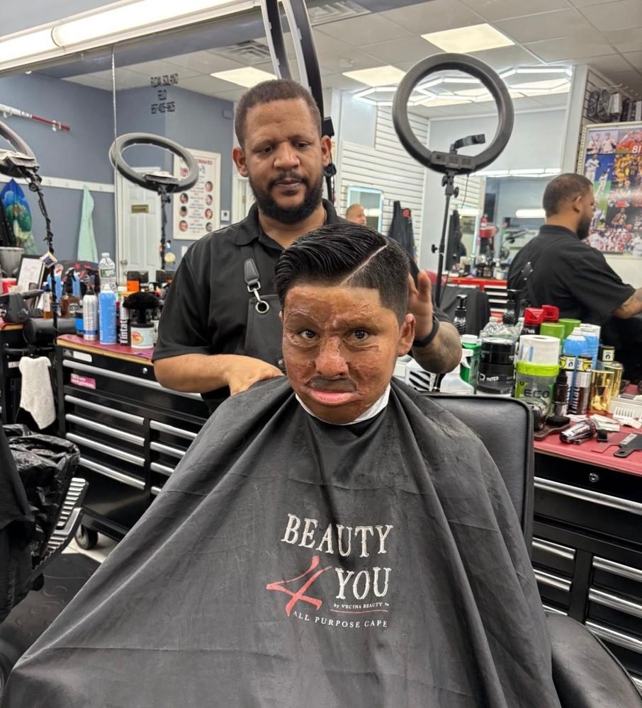 A boy getting a haircut at a local barbershop