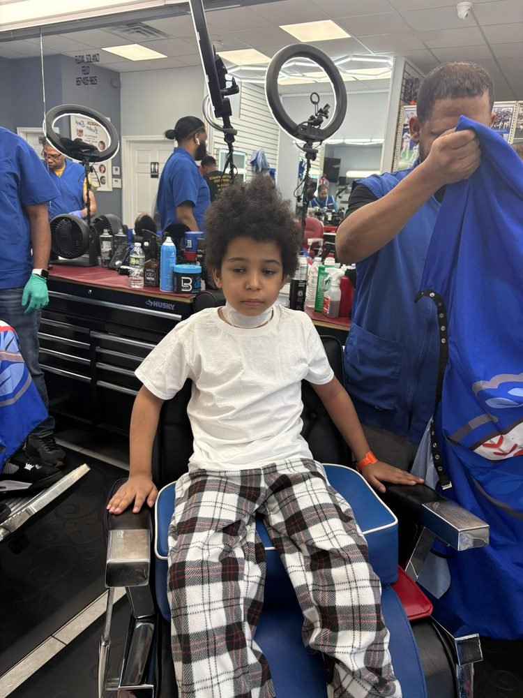 A boy at a neighborhood barbershop